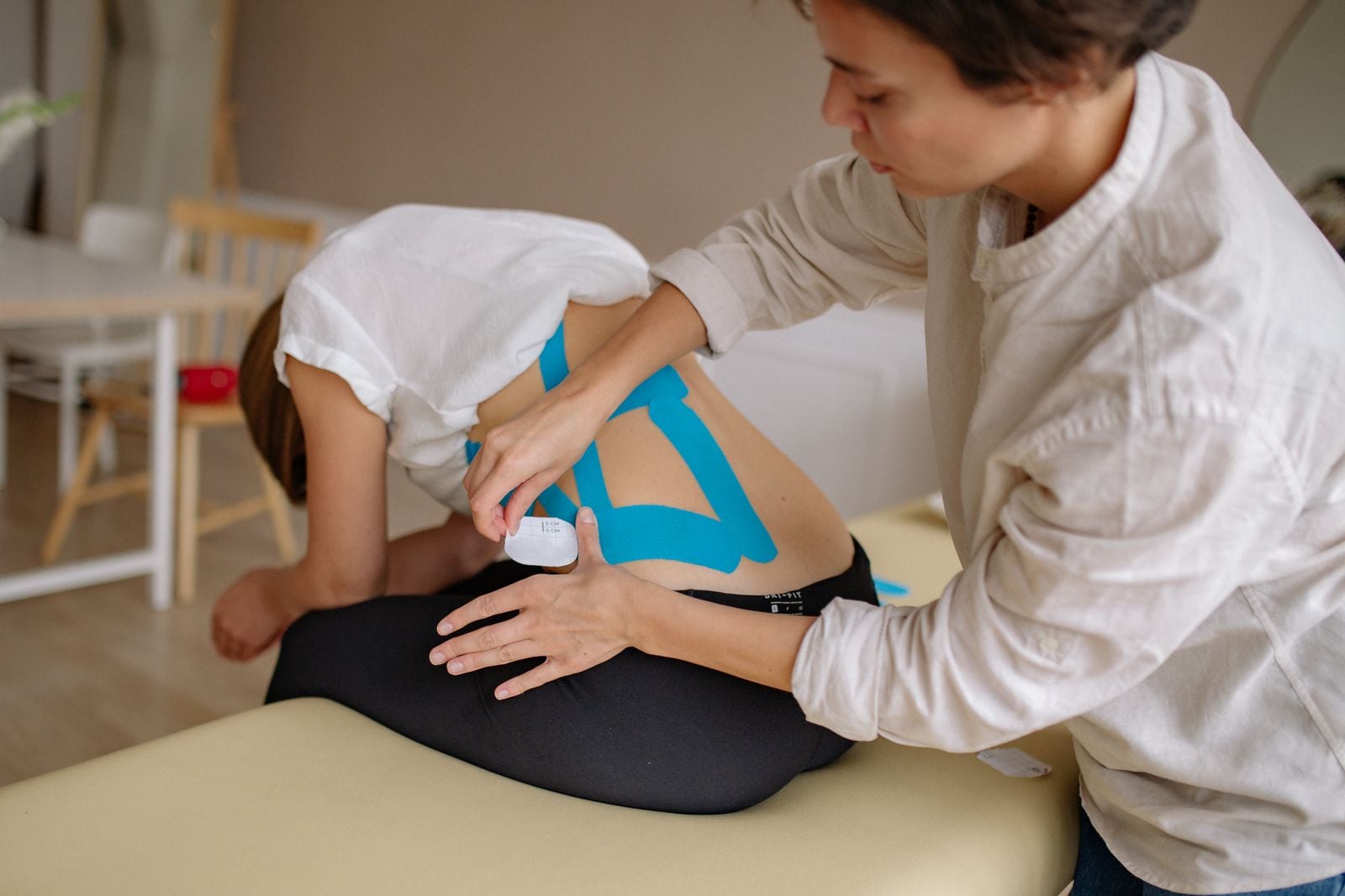 Clinician treating a patient's back in a clinic