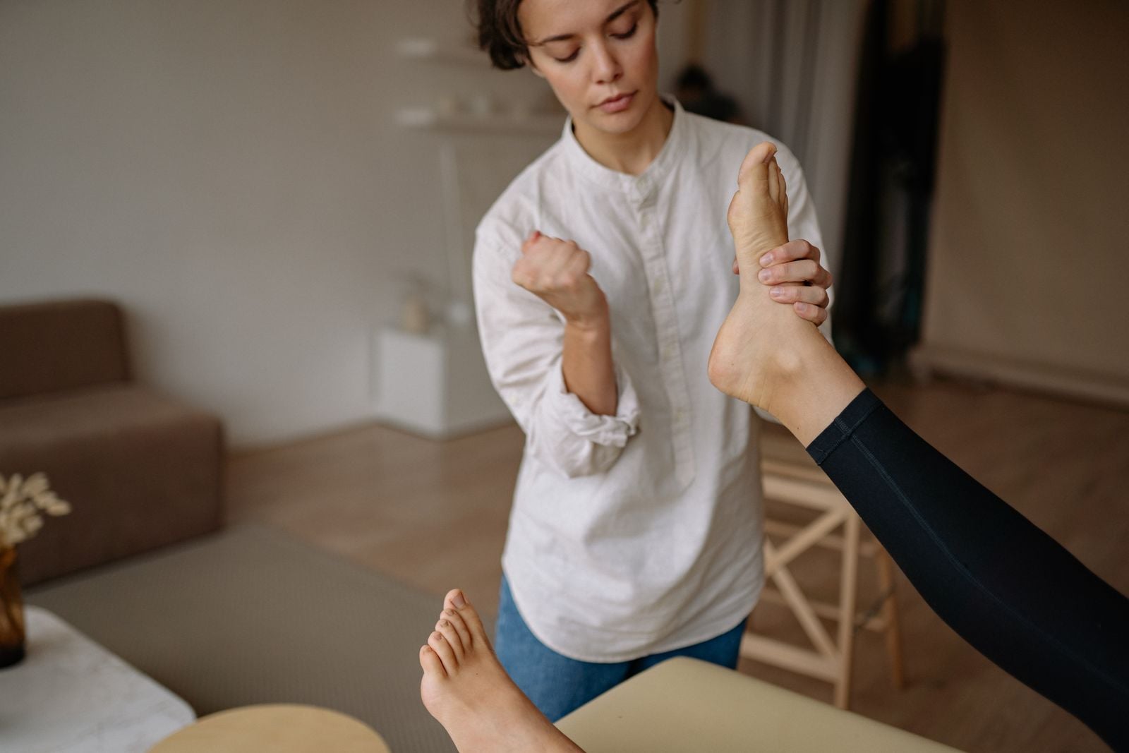 Hands working on the sole of a foot