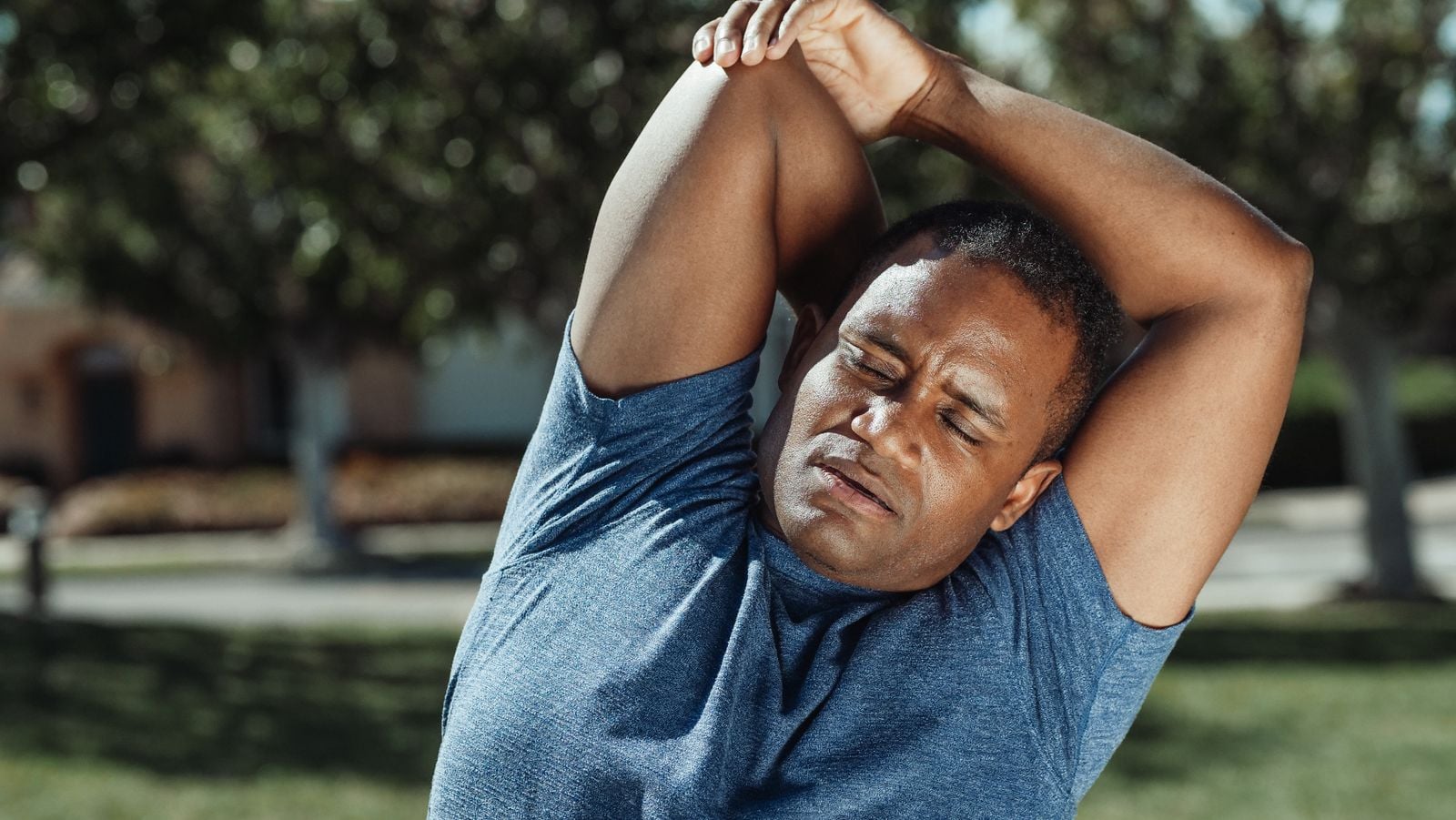Photo illustrating a person stretching a stiff neck and back