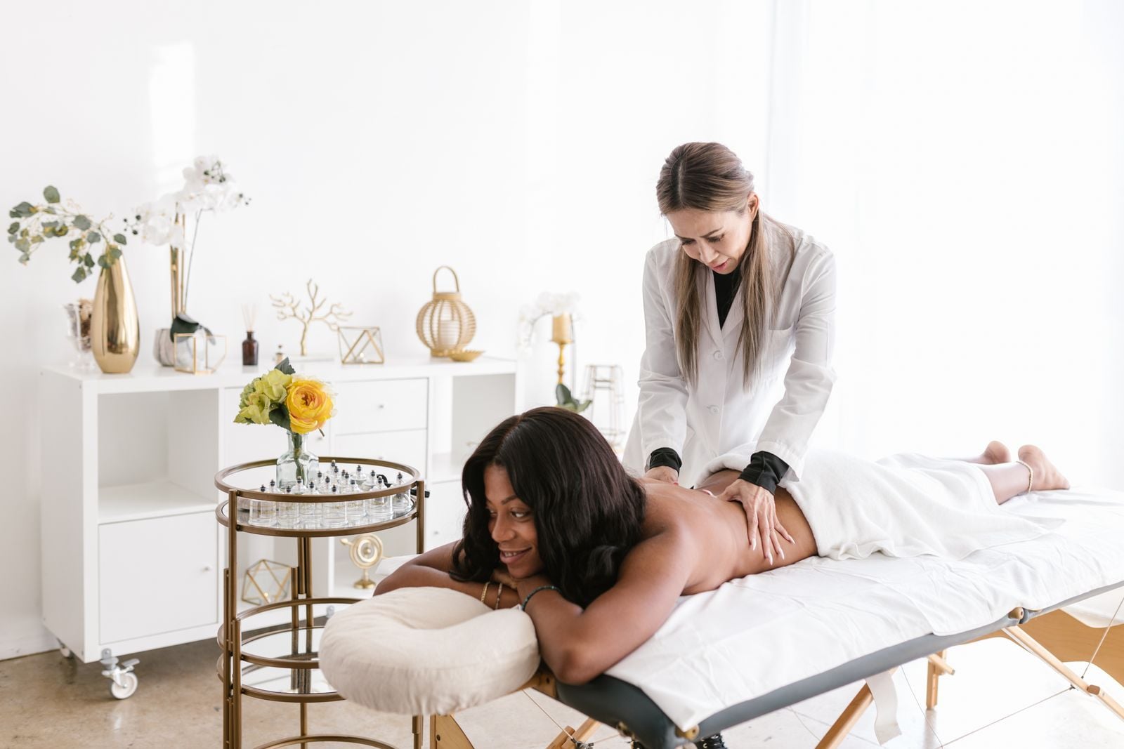 Smiling woman receiving a back massage on a treatment table