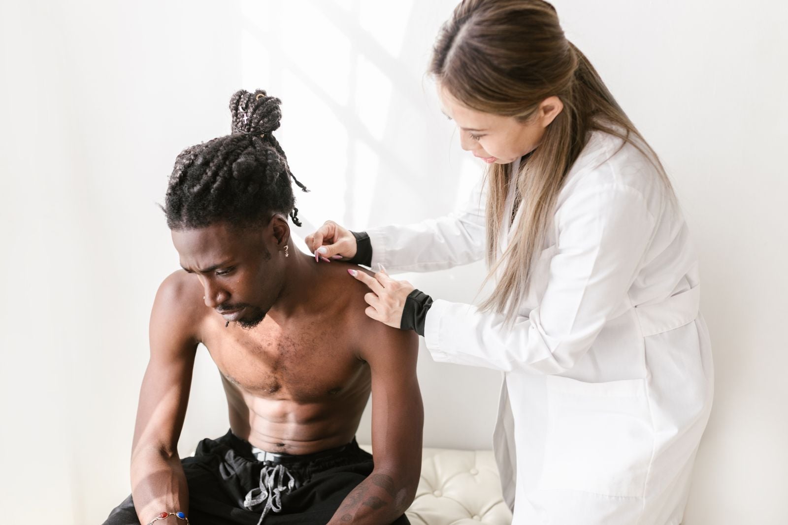 Illustrative stock photo of dry needling in a shoulder muscle