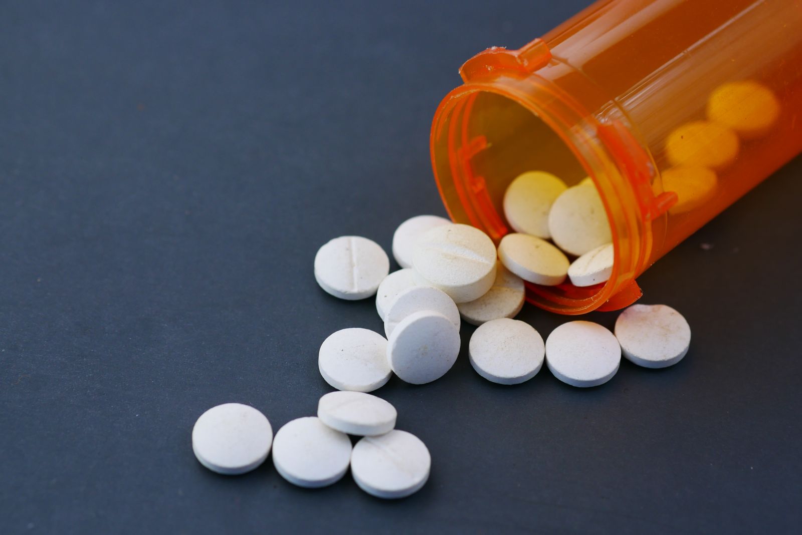 Tablets spilling from a prescription pill bottle