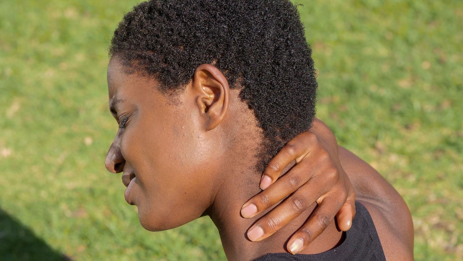 Person rubbing a stiff, sore neck