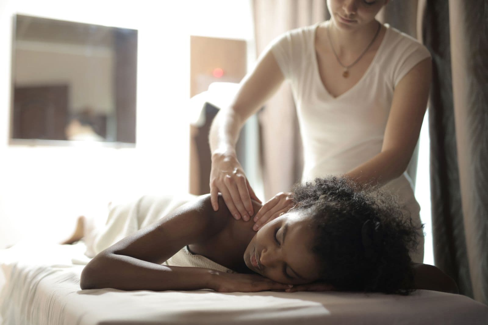 Illustrative stock photo of hands-on soft tissue work on the neck and shoulder