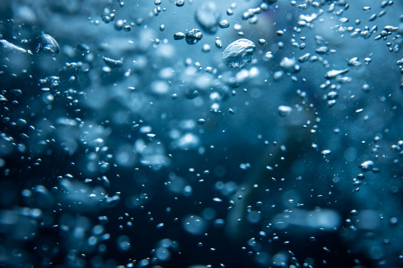 Illustrative image of bubbles rising through blue water
