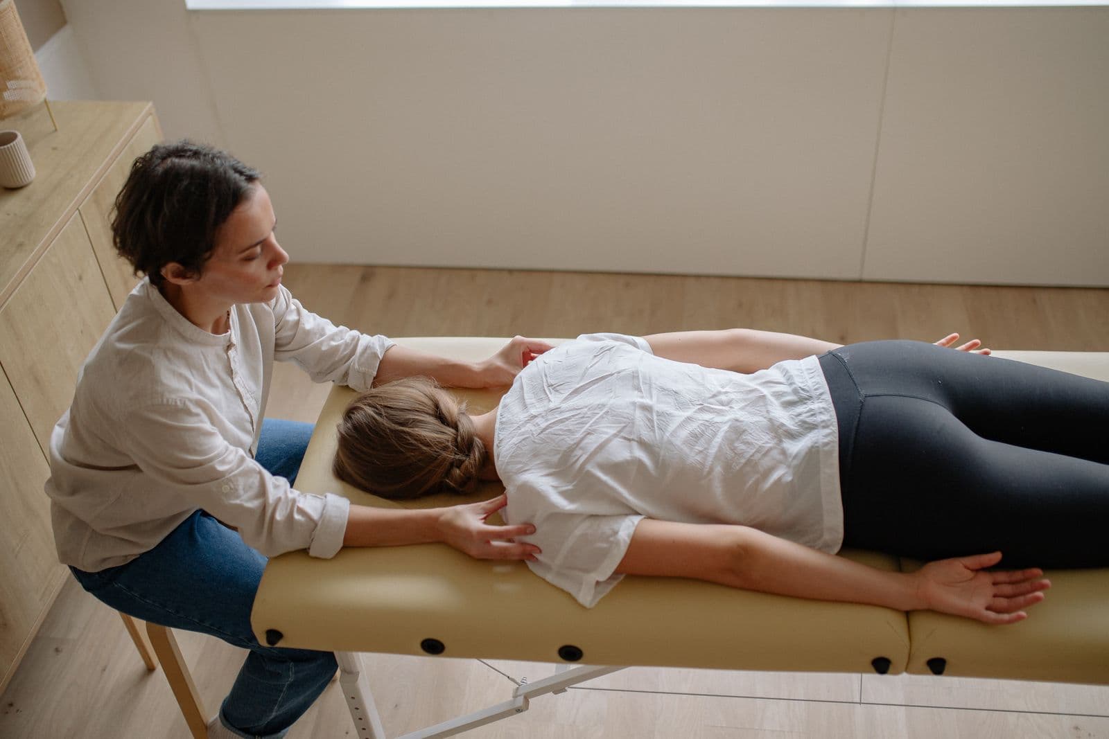 Illustrative stock photo of a hands-on back treatment