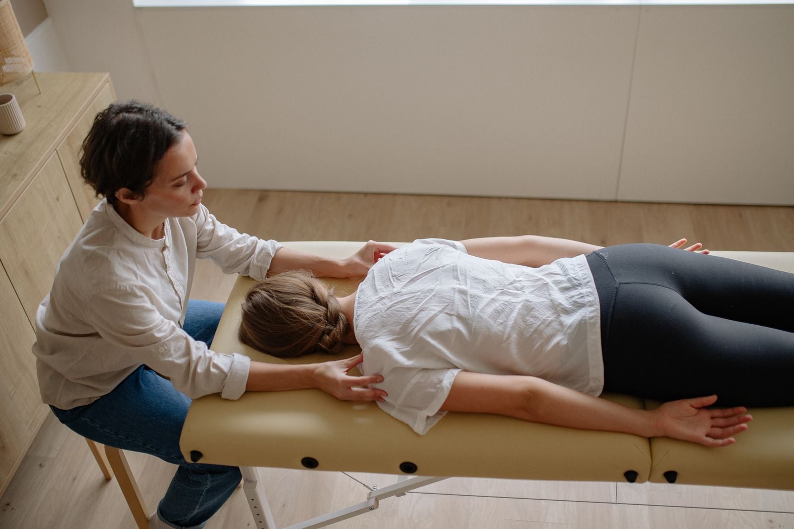 Illustrative stock photo of a hands-on back treatment